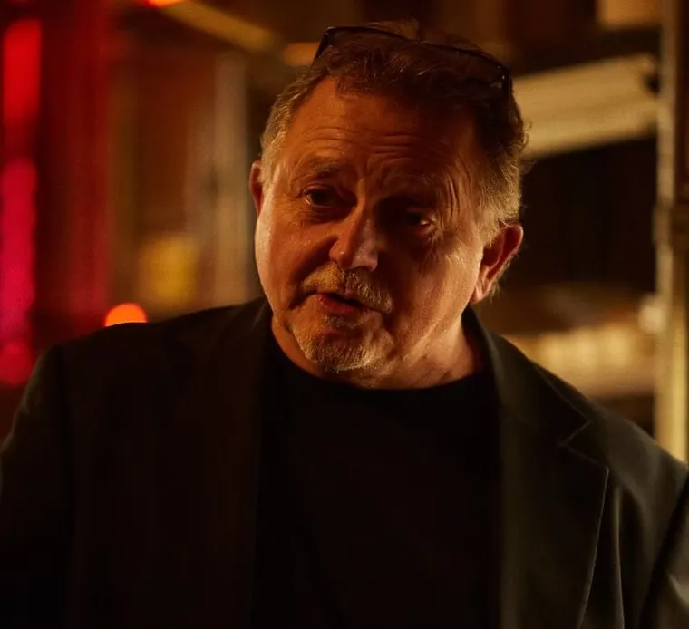Older man with a serious expression