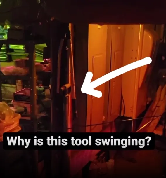 Dimly lit room with tool swinging