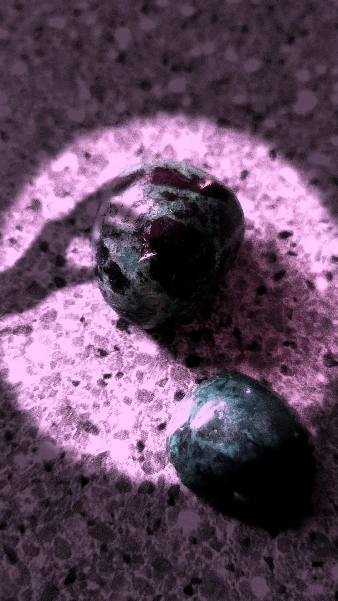 Stones illuminated by soft purple glow.