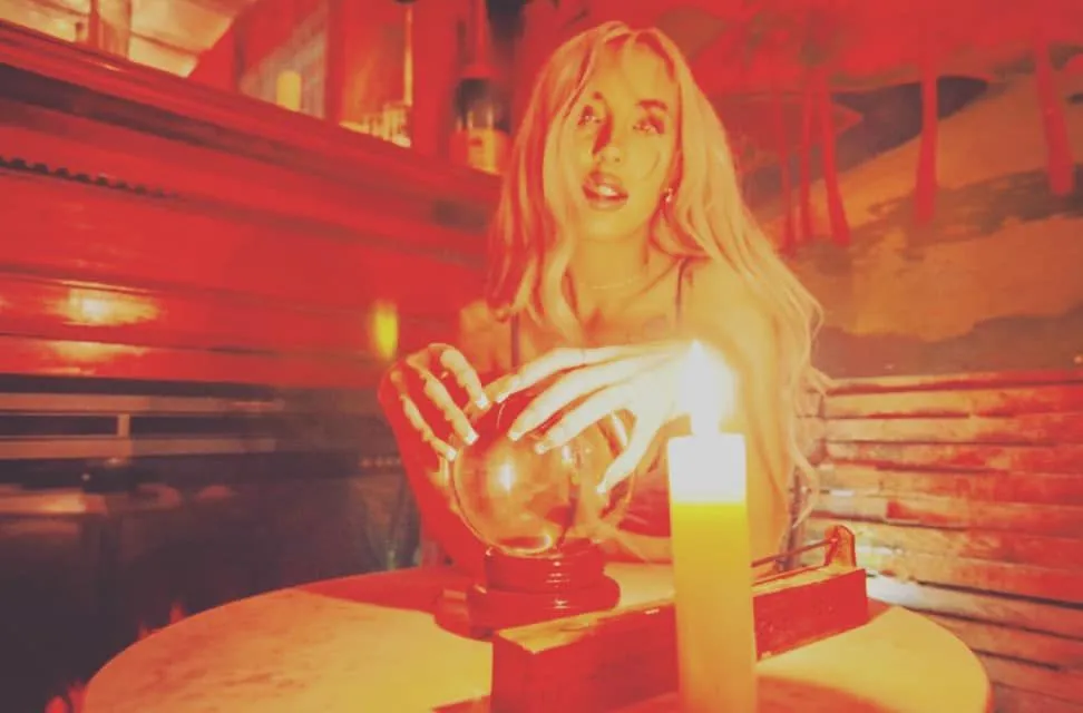 Mystical scene with candlelight and crystal ball.