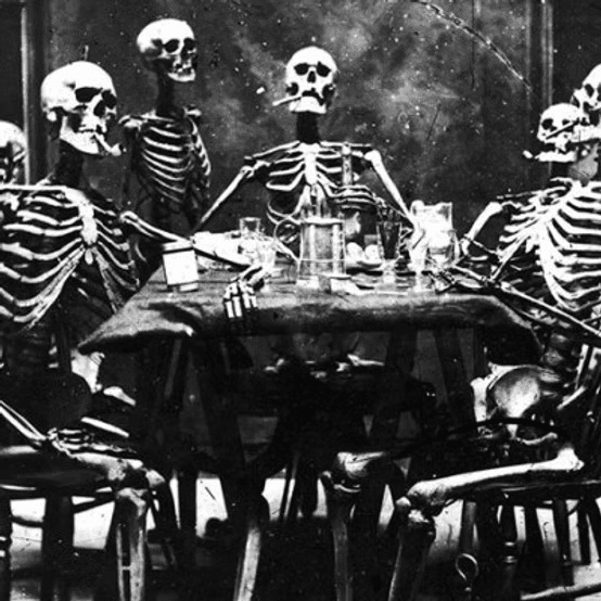 Skeletons sitting around a dining table