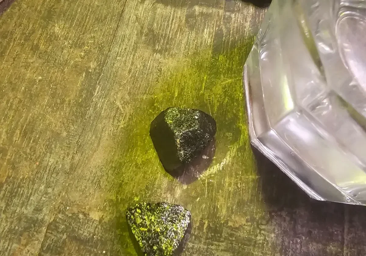 Dark stones near glass object