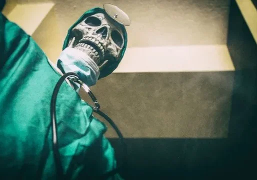 Skull-faced doctor wearing scrubs