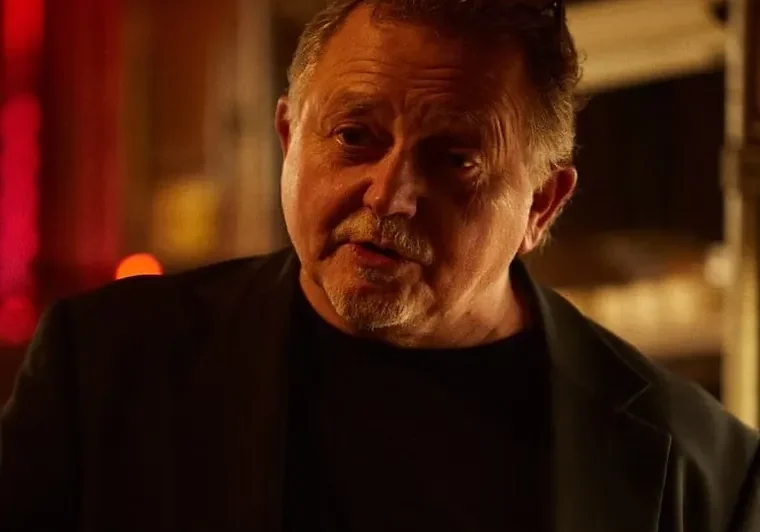 Older man with a serious expression