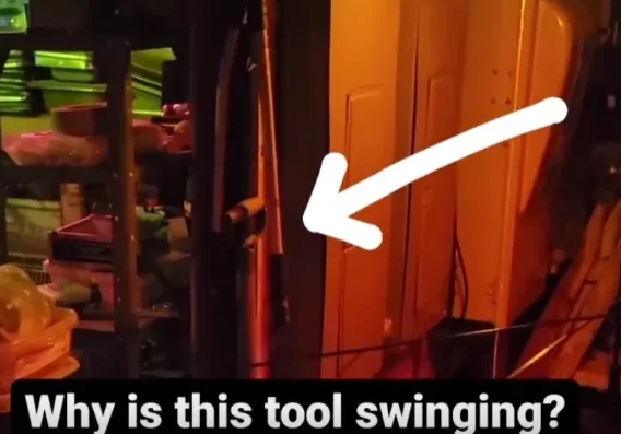 Dimly lit room with tool swinging