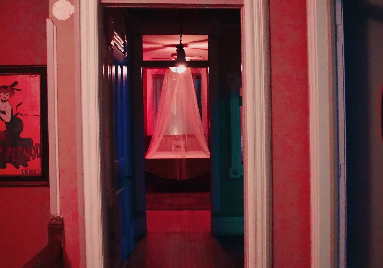 Atmospheric hallway featuring a central chandelier