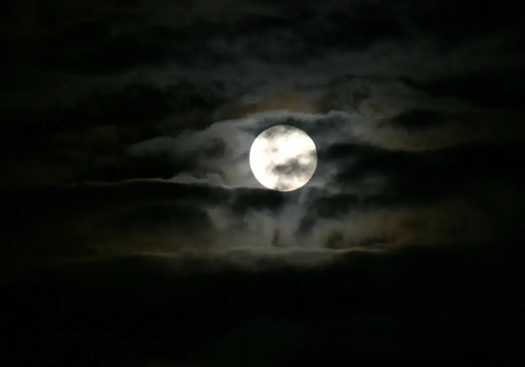 Moonlight through cloudy night sky