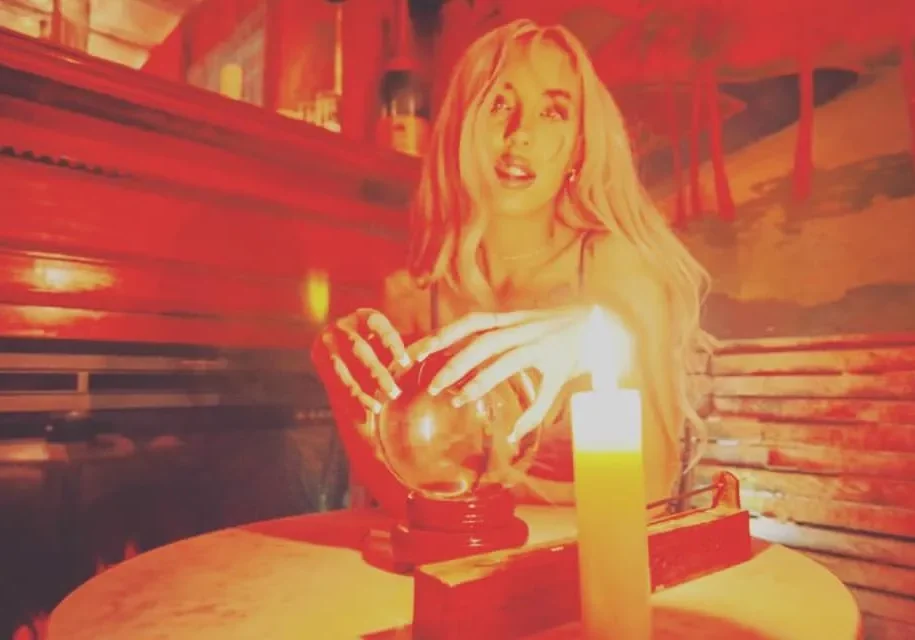 Mystical scene with candlelight and crystal ball.